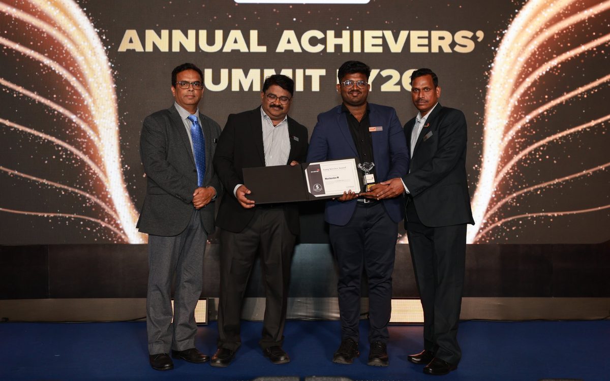 Long Service Award presented on stage at the Annual Achievers Summit FY26